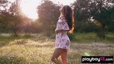 Petite Filipina Kit Rysha stripping and posing nude at a wildflower field