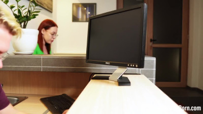 Fucking a redhead behind her working desk