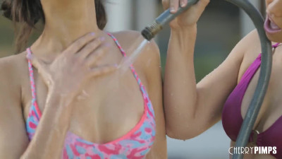 Alina Lopez and Eliza Ibarra in an outdoor paddling pool in several lesbian scenes